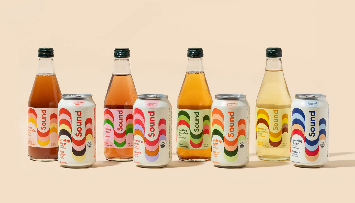 An assortment of Sound sparkling water cans and glass bottles, arranged in a row against a beige background. Each beverage features a colorful, wavy design on the label, with different flavors such as blood orange, grapefruit, tangerine, chamomile, and blueberry.