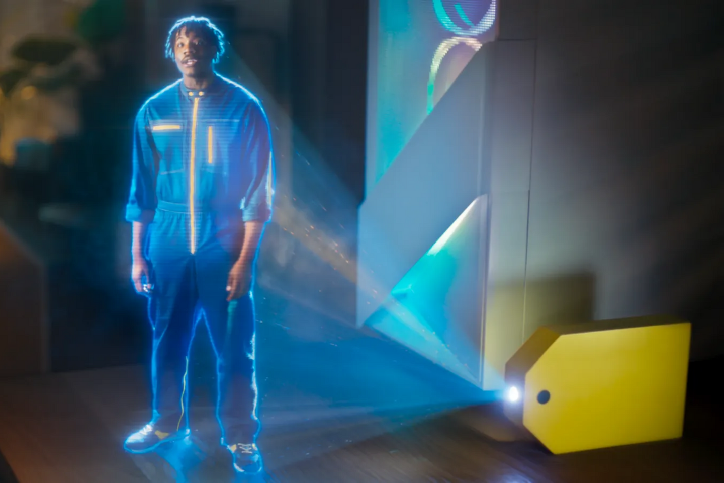 A holographic figure of a man in a futuristic jumpsuit is projected from a glowing yellow Best Buy price tag, surrounded by blue light beams.