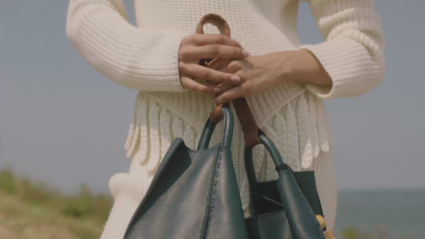 The Sak marketing reel showing woman holding handbags