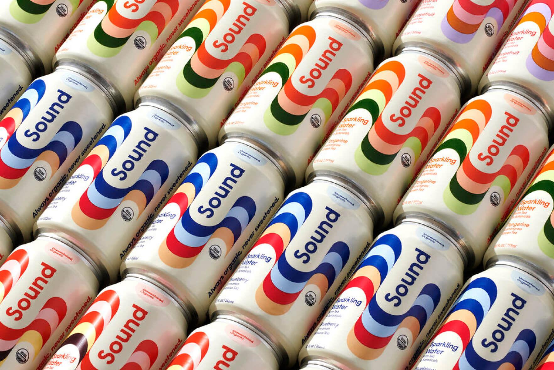 Rows of Sound sparkling water cans arranged diagonally, featuring colorful, wavy designs in blue, red, orange, and green on a white background.